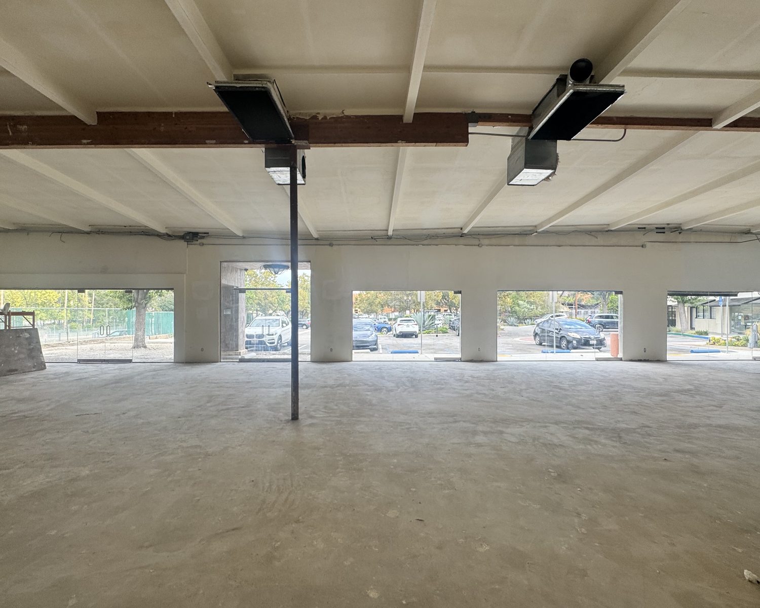 Interior of Suite A-14 looking toward the full-height storefront glass line